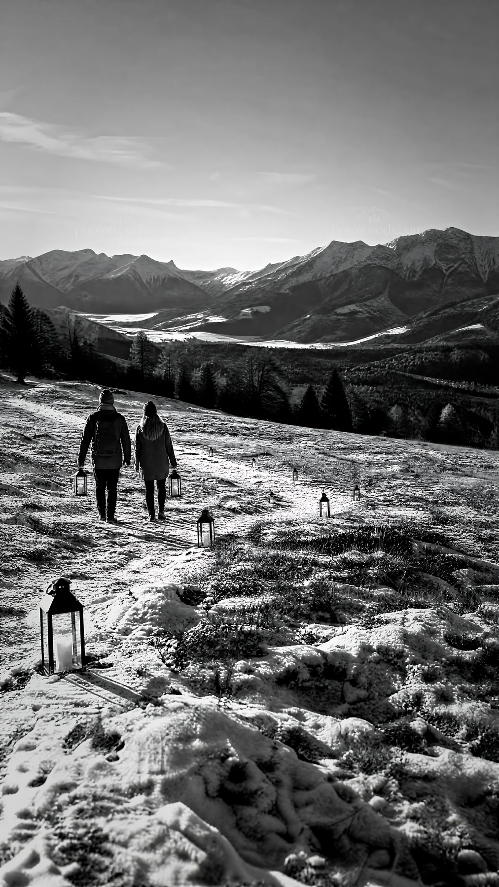 Walking on a snowy path in a Christmas meadow with lanterns - AI-generated stock image