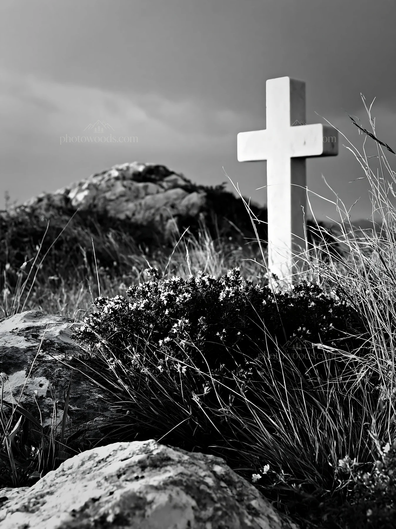 White Christian cross in remote meadow with rocks and grass - AI-generated stock image