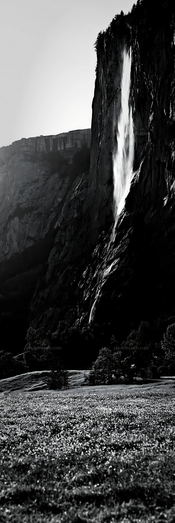Lauterbrunnen Valley meadow with light rays and waterfall - AI-generated stock image