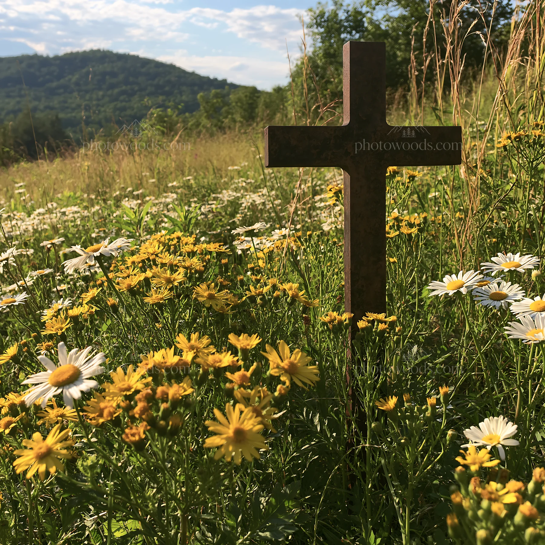 Christian cross in yellow wildflower meadow with mountains - AI-generated stock image