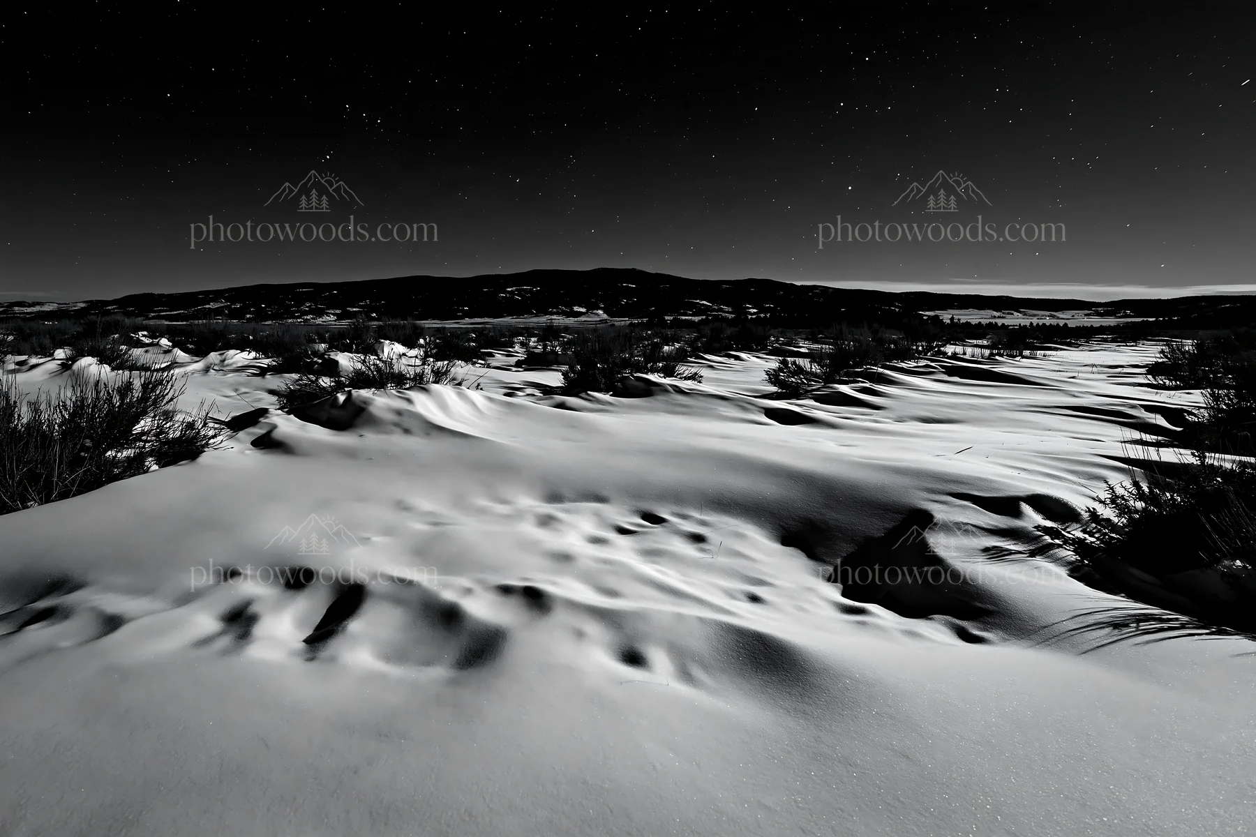 Snowdrift meadow under night sky with distant mountains - AI-generated stock image