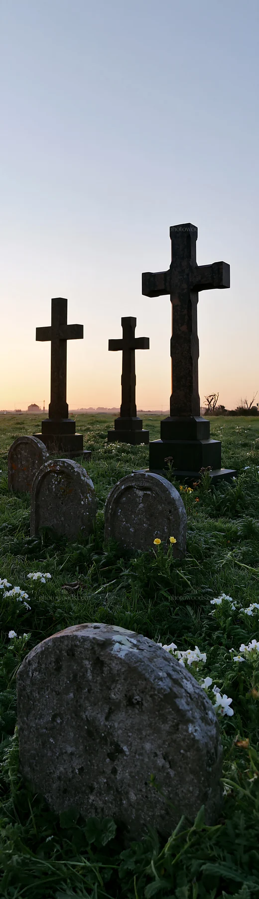 Three Christian crosses in a meadow at sunrise - AI-generated stock image