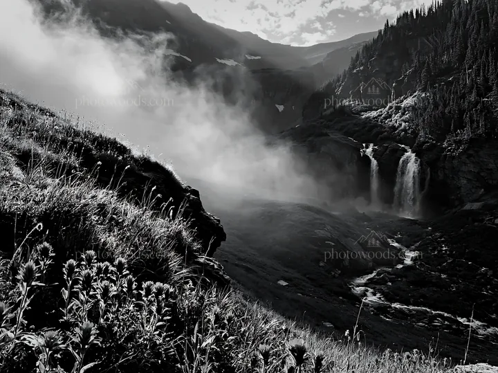 Misty mountain waterfall in meadow landscape - AI-generated stock image