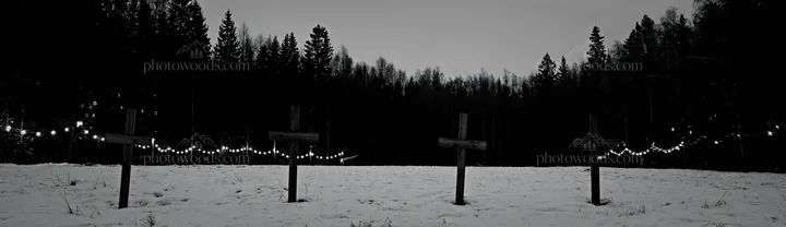 Four wooden crosses in a Christmas meadow at dusk - AI-generated stock image