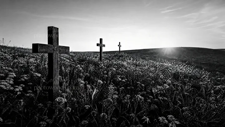Christian crosses on rolling meadow beneath sunrise - AI-generated stock image