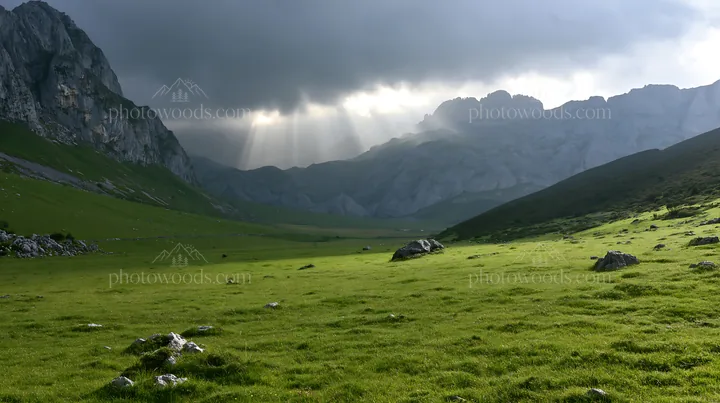 Sunrays shine through clouds over Picos de Europa meadow - AI-generated stock image