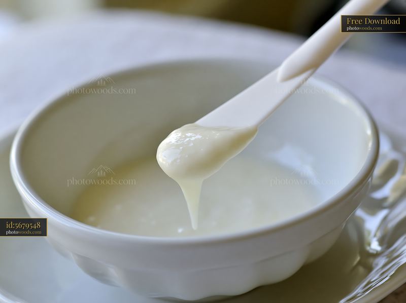 Cream dose on a cosmetic spatula above a bowl