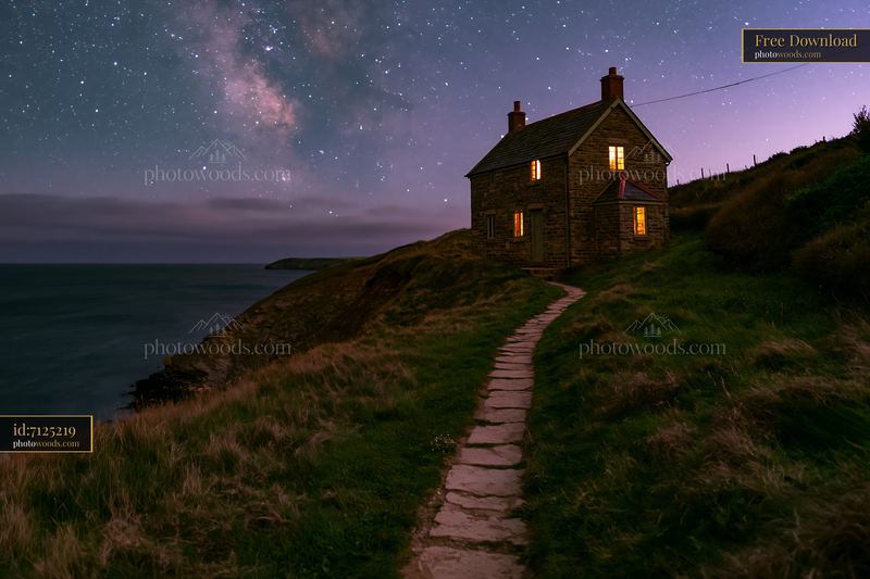 Cottage under stars with a stone path near the sea