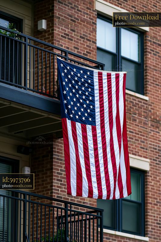American flag displayed on balcony of apartment building