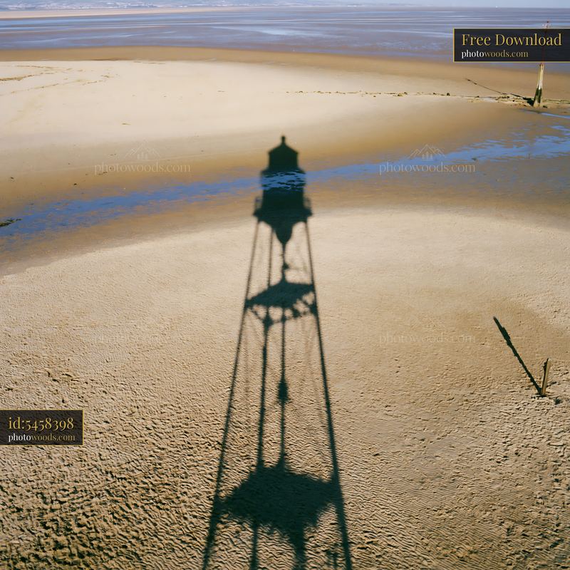 High view of a shadow from a structure on a sandy landscape