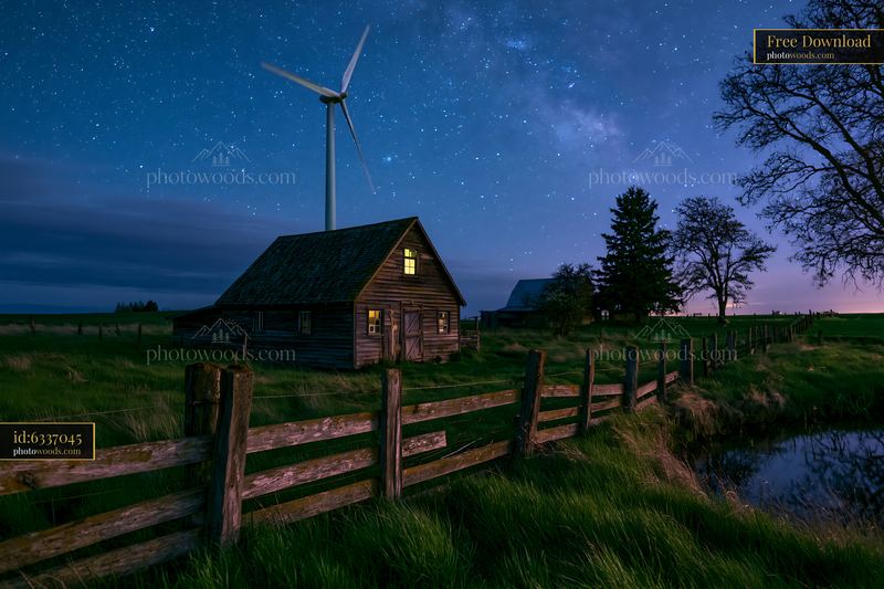 Starry night above a rural wind turbine with a farmhouse