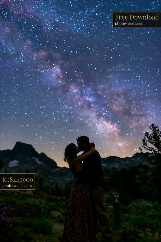 Young couple kissing under a starry sky with the Milky Way