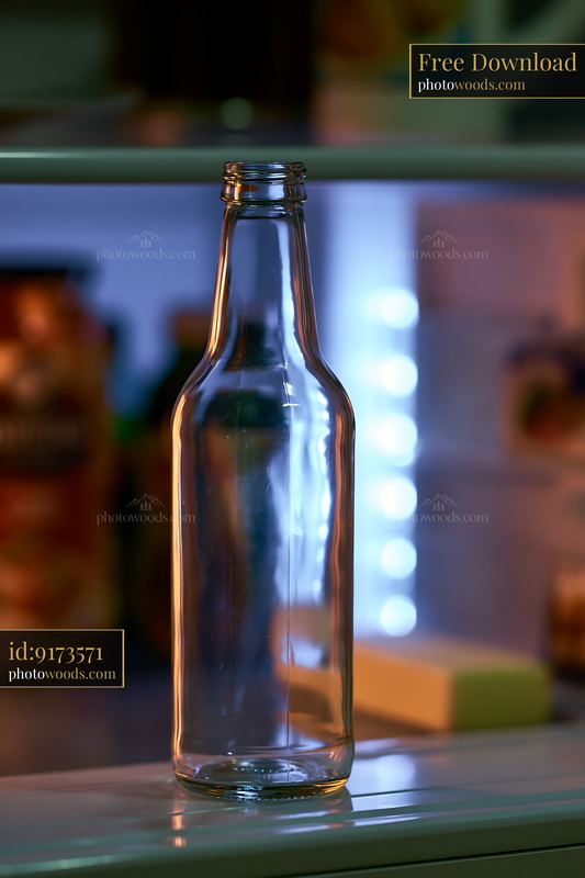 Empty bottle on a shelf inside a refrigerator