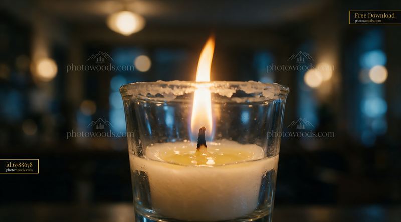 Macro View of a Burning Candle in a Glass Holder