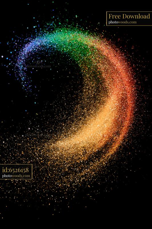 Colorful salt and glitter abstract pattern on a black background