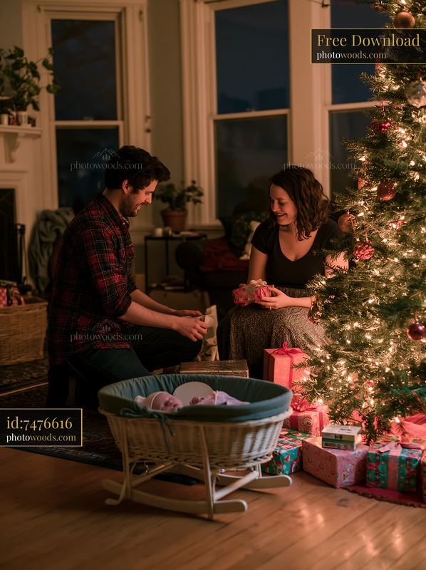 Parents arranging gifts beside a decorated Christmas tree