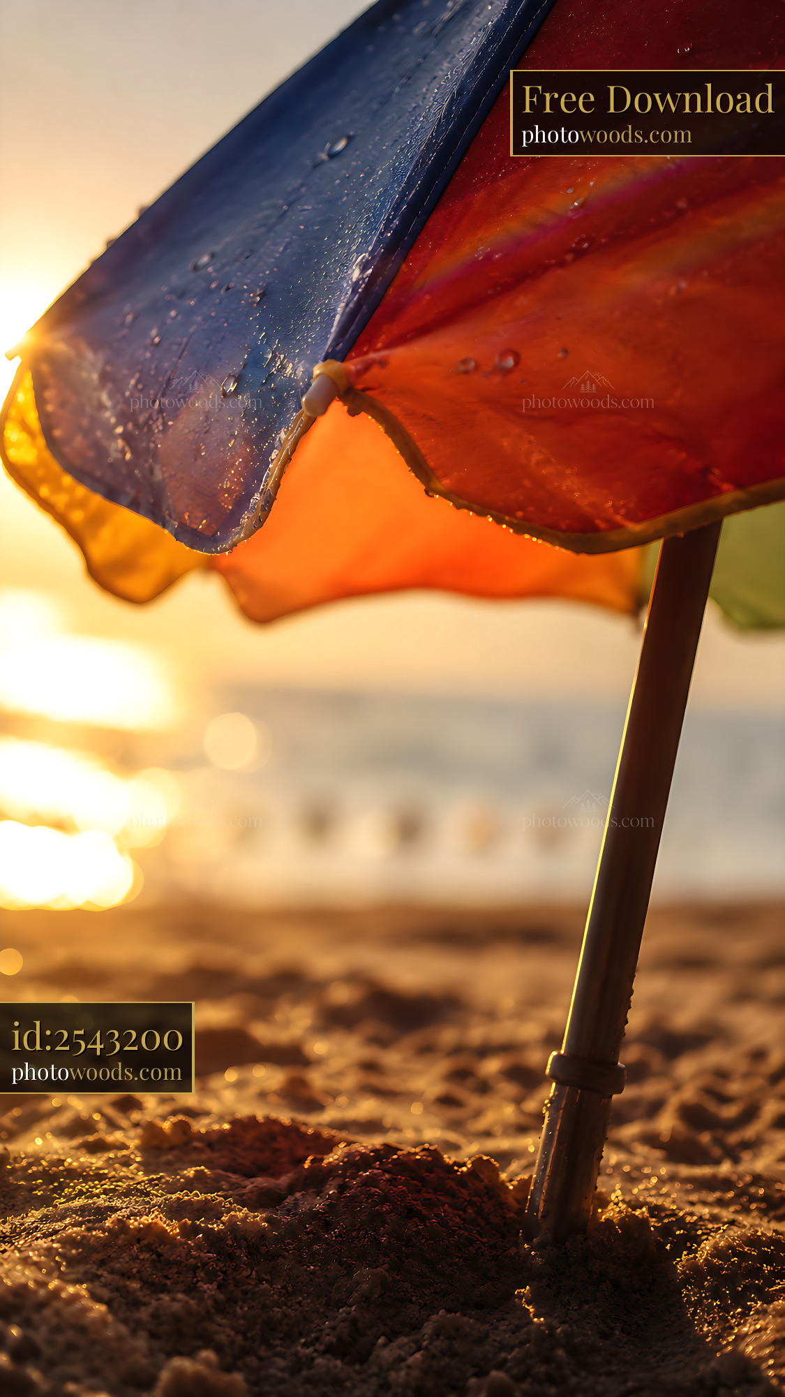 Umbrella Stands on the Beach as Sun Sets Behind the Ocean Waves