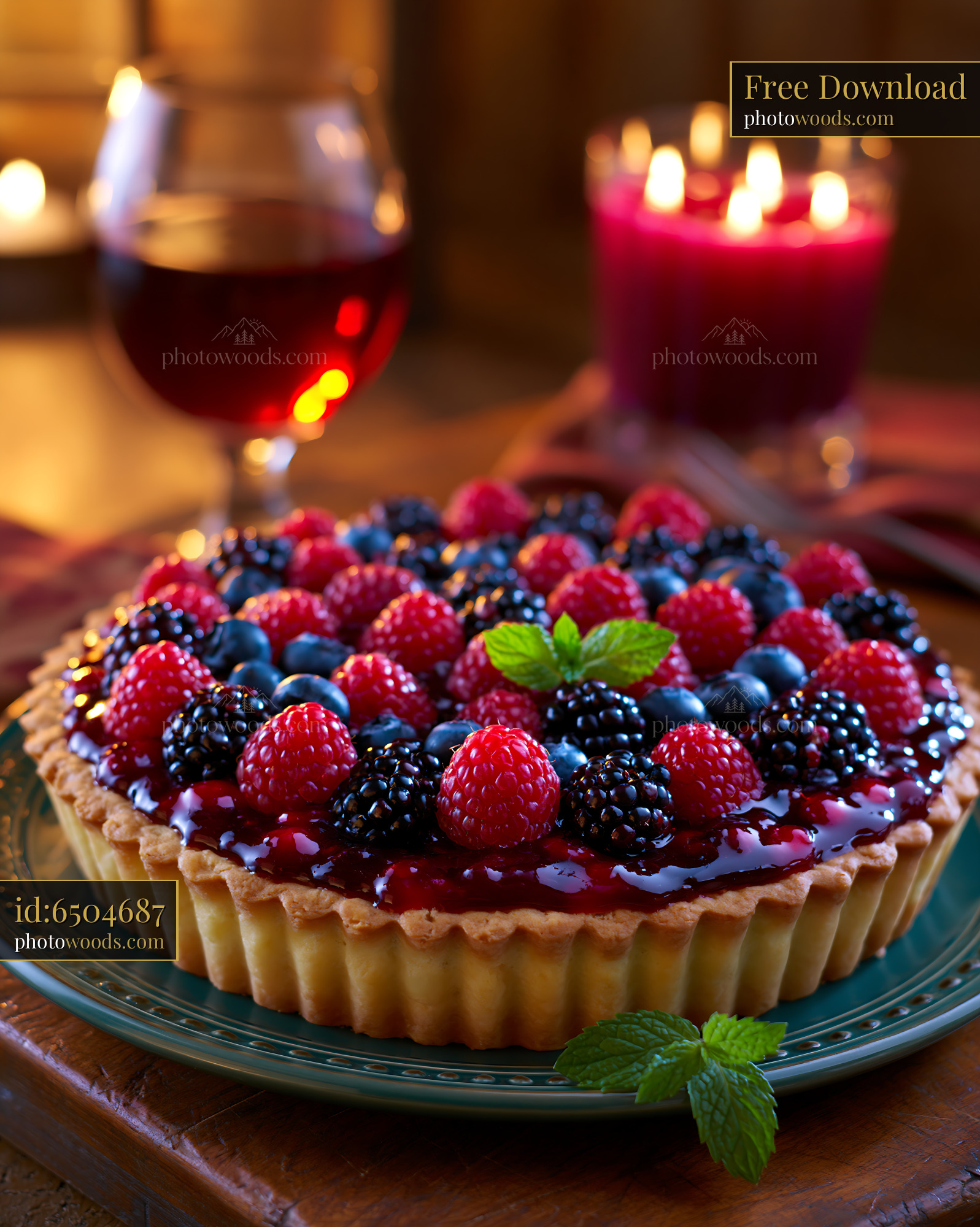 Berry Tart With Glossy Glaze and Mint on a Wooden Table