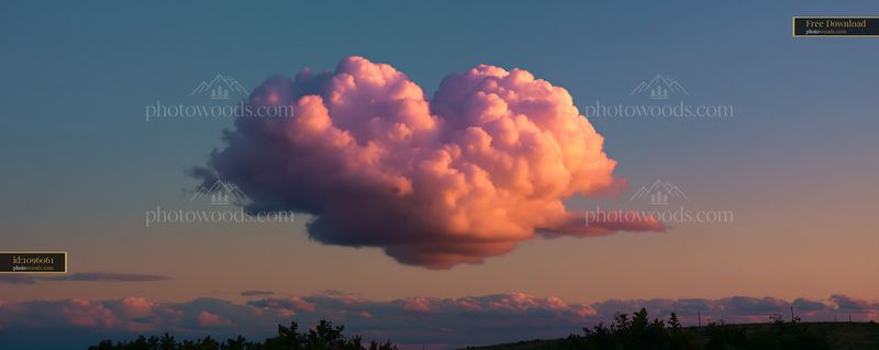 Dramatic pink cumulonimbus cloud at sunset