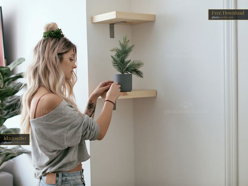 Woman decorating a small apartment with a potted holiday tree
