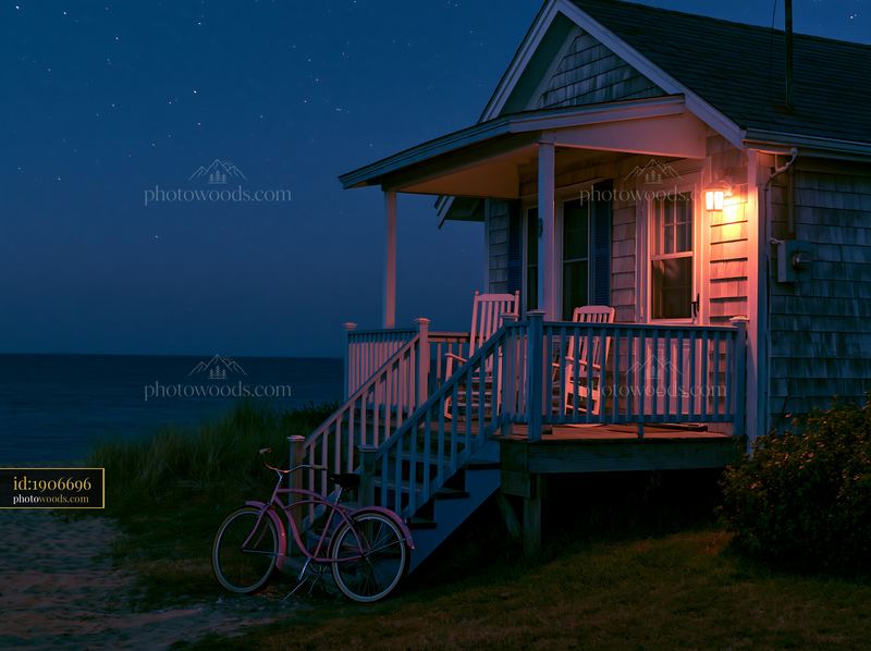 Beach house under stars with bike at porch