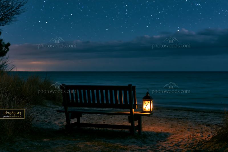 Starry night over a secluded island beach with a lantern