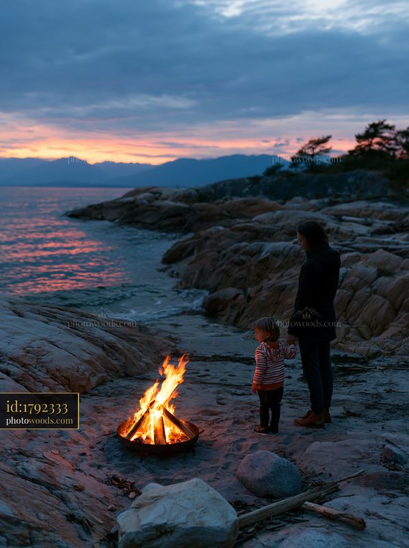 Coastline with beach bonfire during sunset with adults and children