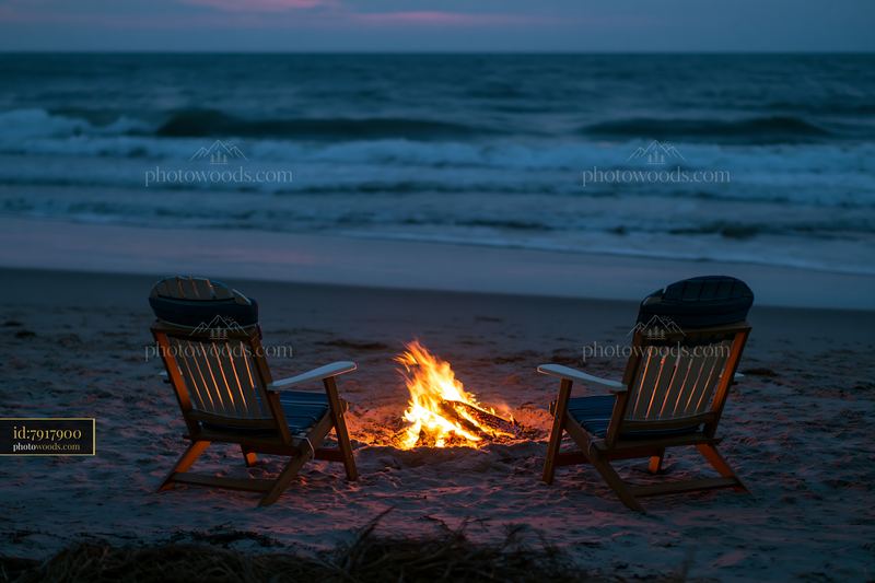 Coastline with beach bonfire at dusk
