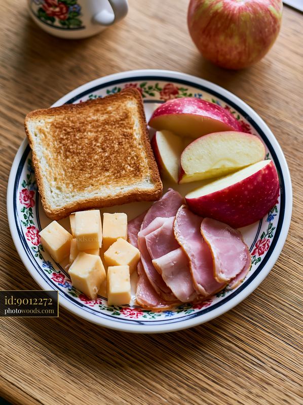 Breakfast plate with cold cuts, cheese, toast, and apples