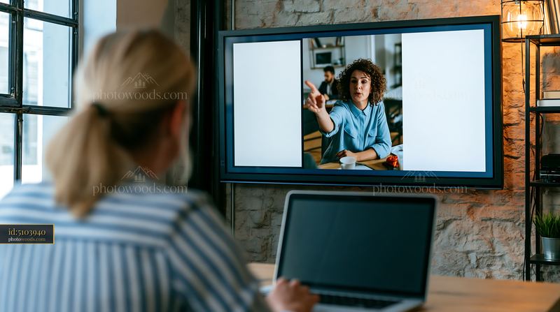 Businesswoman leading hybrid meeting with blank screen