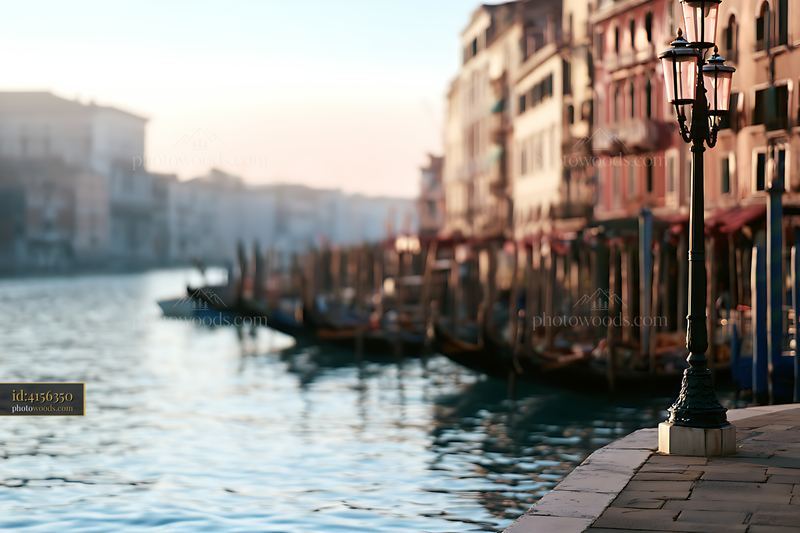 Canal view with classic lamp post and gondolas in the distance