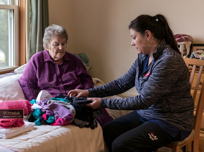 Caregiver assisting dementia patient with daily task