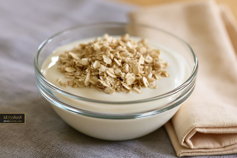 Cream dose with oat flakes in a clear bowl