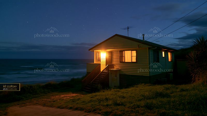 Coastal home with ocean horizon under stars at night