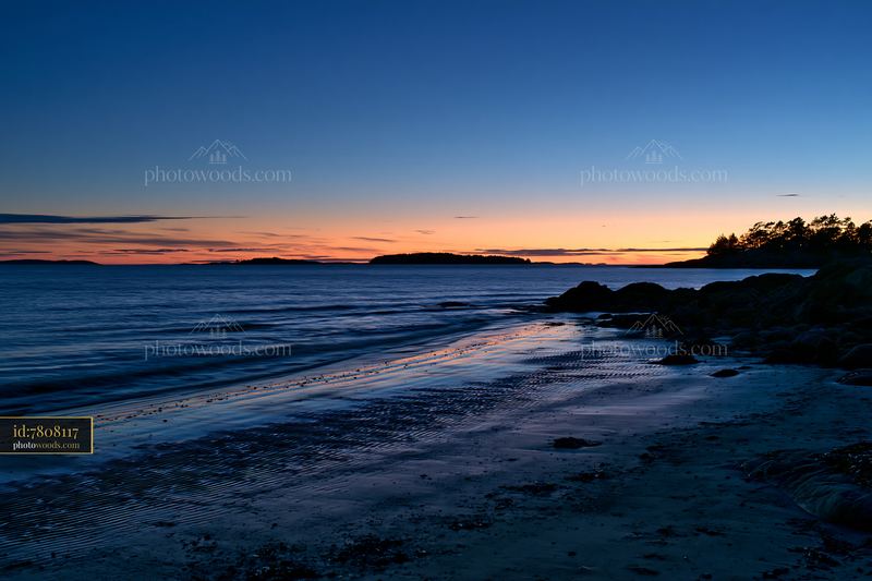 Coastline at dusk with an island visible offshore