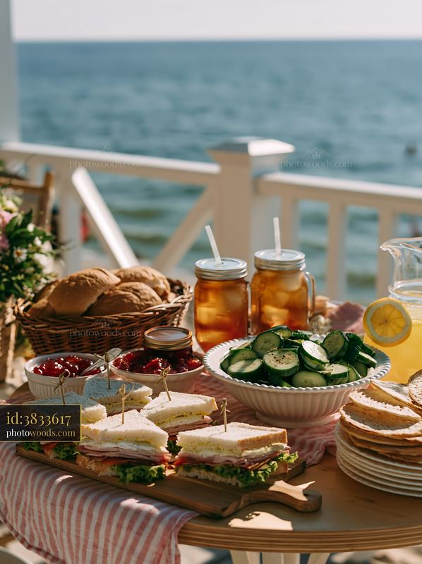 Beach picnic buffet with sandwiches and drinks by the ocean