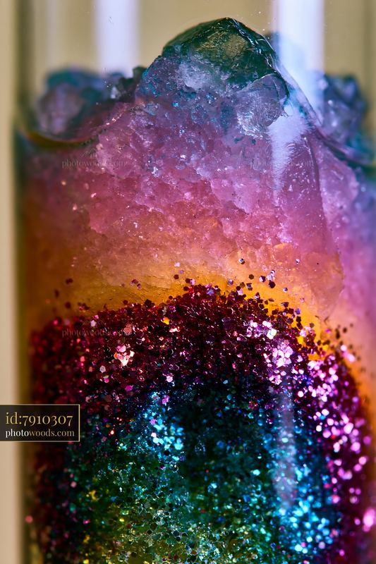 Colorful salt and glitter abstract pattern in a glass vessel