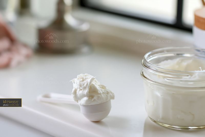 Cream dose measured with a cosmetic scoop on a countertop
