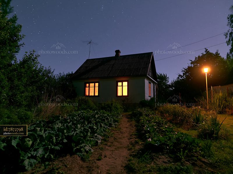 Country house under starry sky with garden and pathway