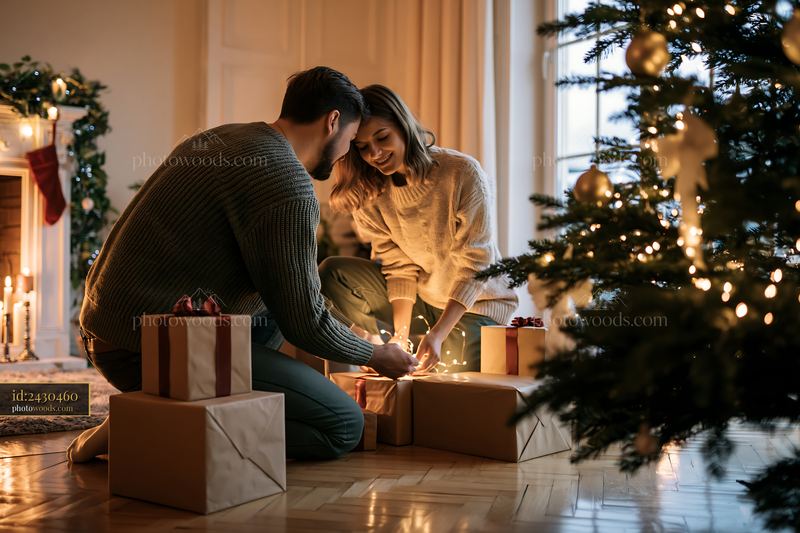 Parents placing gifts under tree in cozy holiday setting