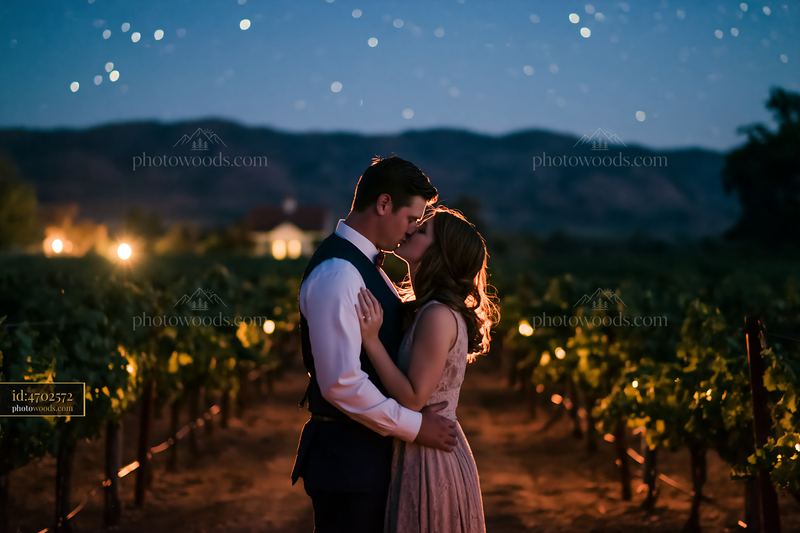 Couple kisses under stars in vineyard during romantic date