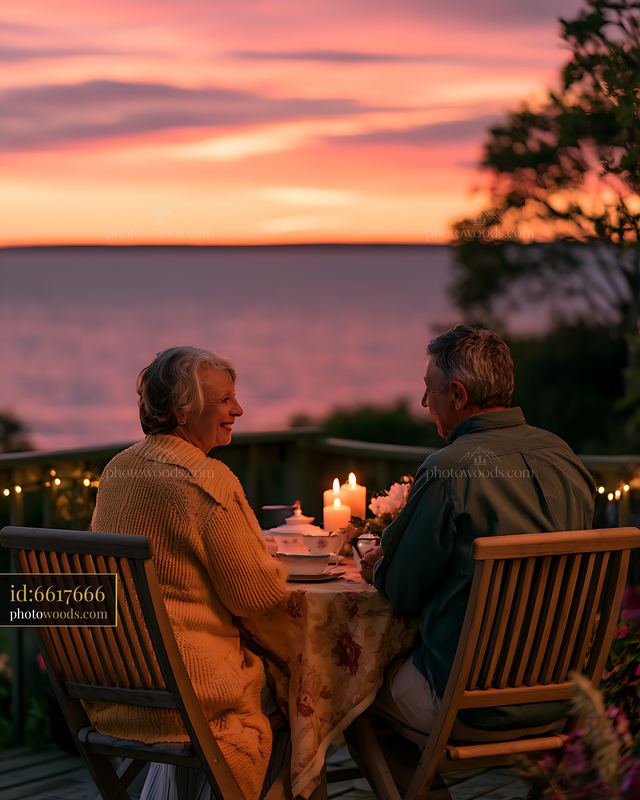 Couple enjoying dinner at sunset by the seaside