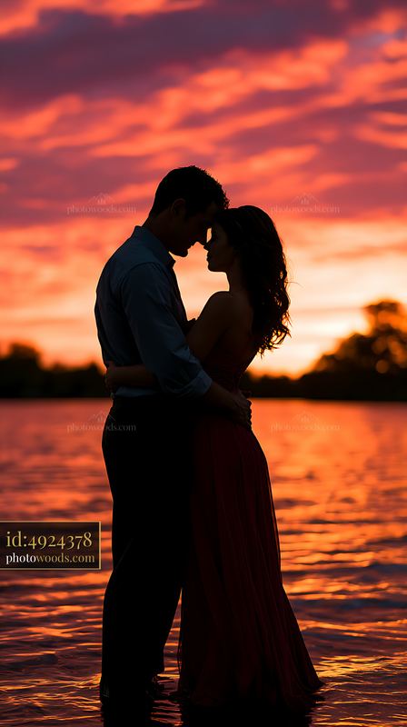 Couple standing close together during sunset by the water