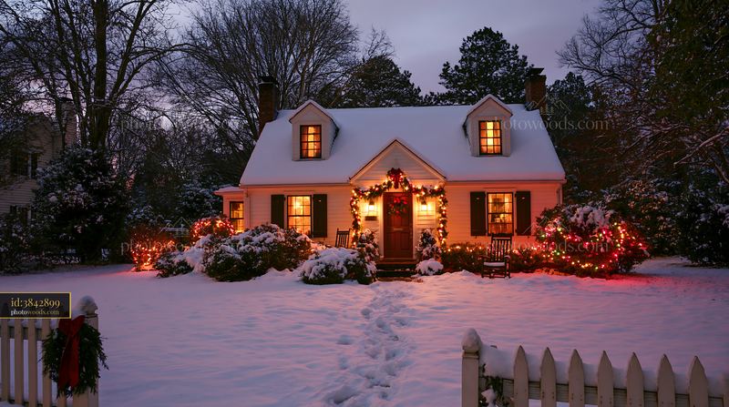 Country cottage decorated for Christmas in winter evening