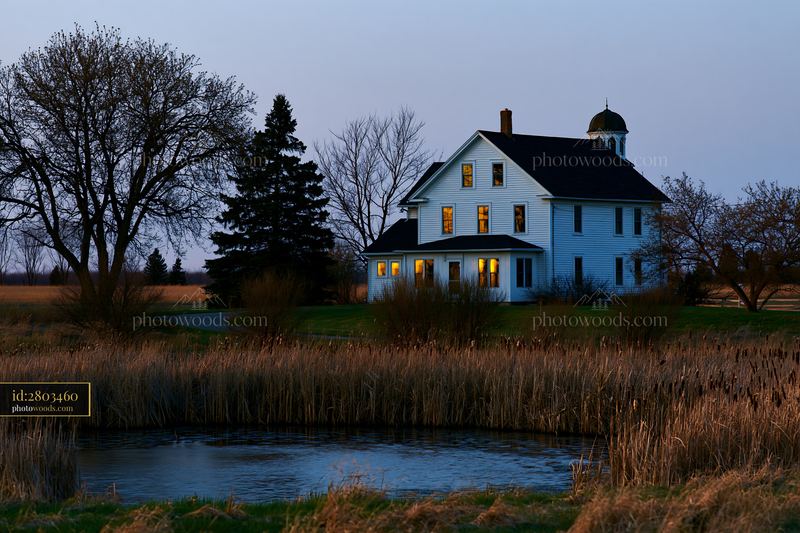 Farmhouse landscape at sunset showcasing a serene setting