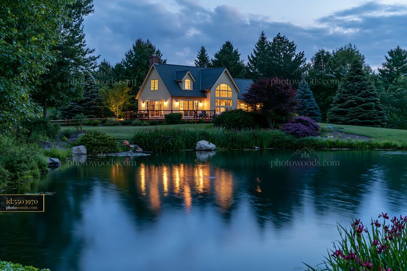 Luxurious garden house beneath evening sky by tranquil water