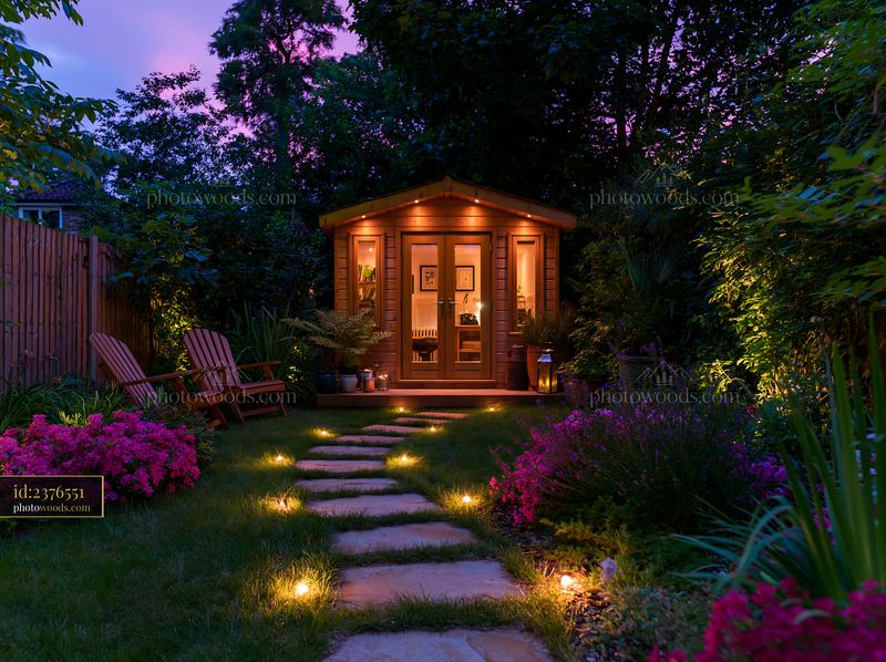 Empty garden studio with pathway illumination at dusk