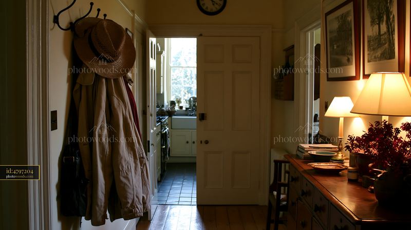 Country house hallway with coat hooks and warm lighting