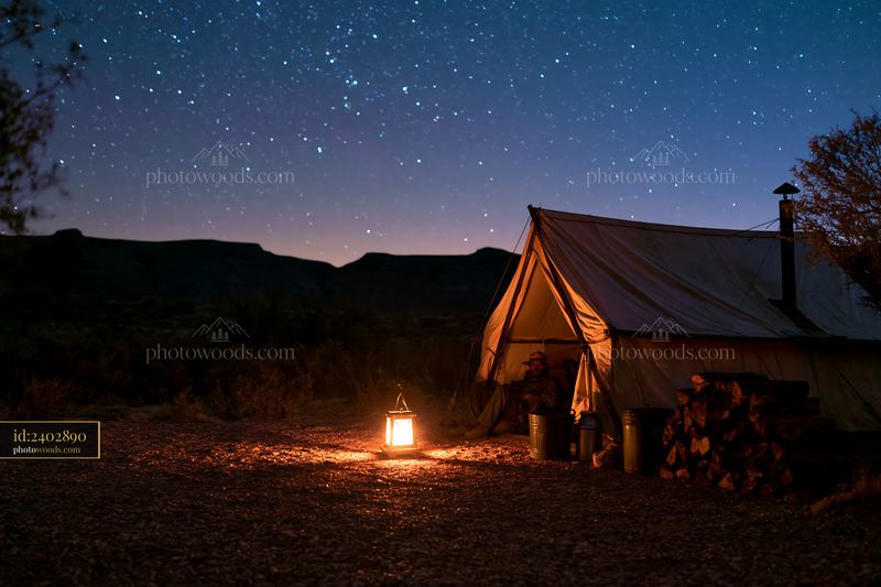 Starry night casting light on a desert campsite