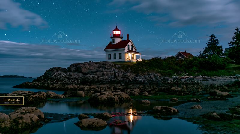 Lighthouse house under stars by the sea at night